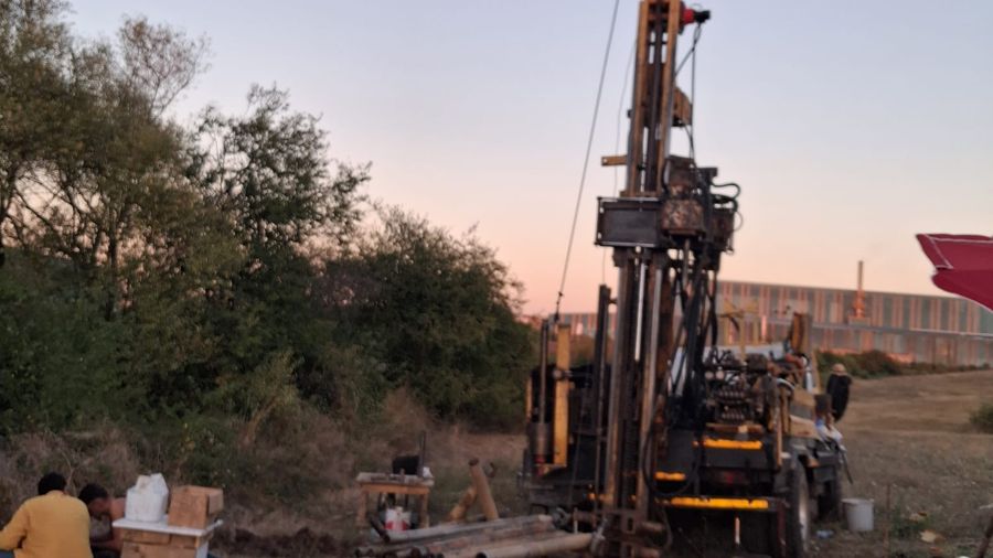 Geotechnical drilling site at sunset, groundwater measurement borehole